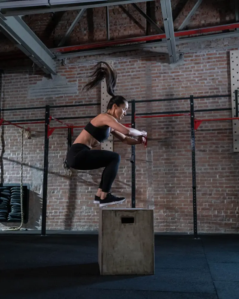 A woman performing a box jump exercise